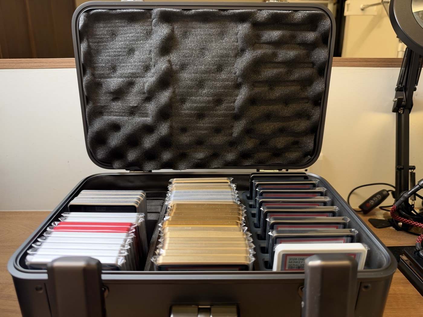 The Kalijoy K CASE open, showing three rows of graded slabs standing vertically in trays inside the aluminium body.
