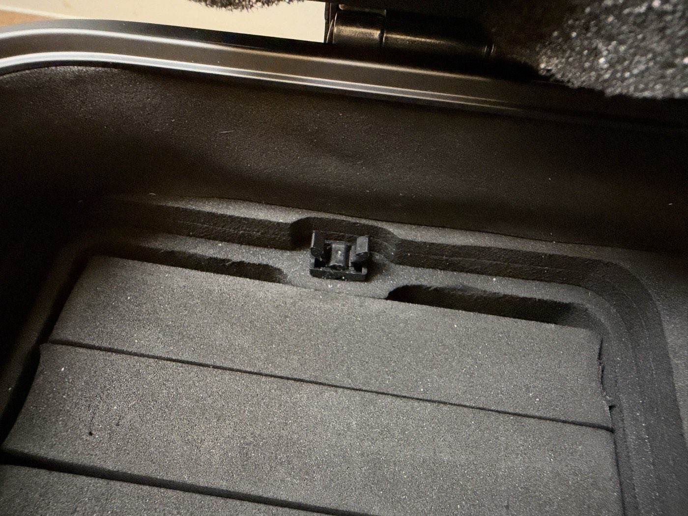 Close-up of the small plastic catch inside the Kalijoy K CASE that secures a removable card tray.