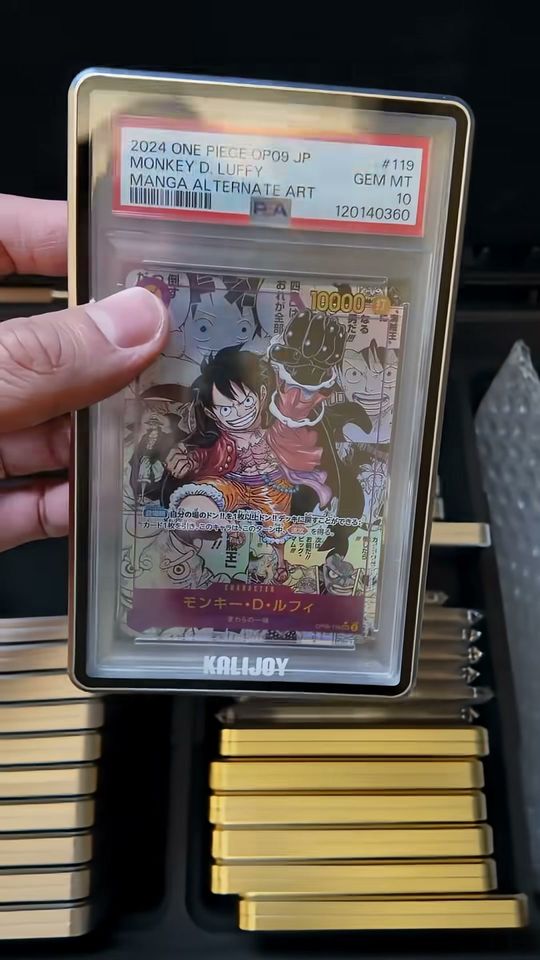 PSA 10 One Piece Luffy in a Kalijoy case, held above a K-Case packed with more Kalijoy cases